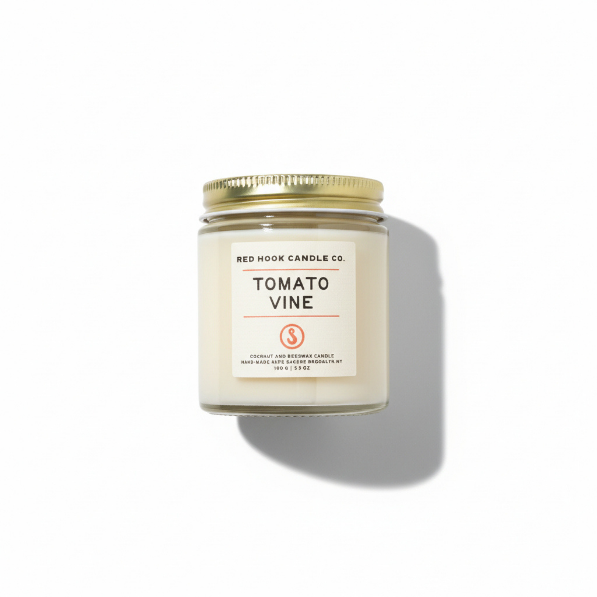 Candle jar labeled 'Tomato Vine' by Redhook Candle Co. on a white background